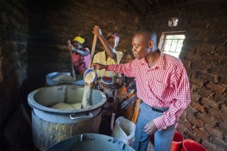 Volunteers prepare food around a stove