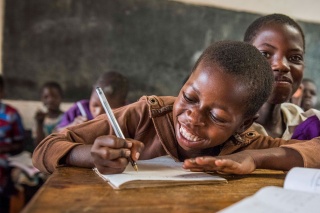 Child in Malawi learning in class