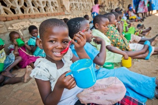 Child in Malawi eating porridge