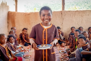 Child in Madagsacar receiving meals