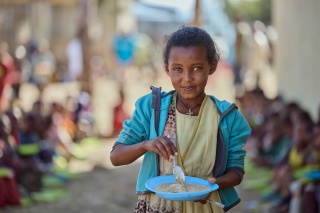 A child eating her school meal in Tigray, Ethiopia