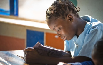 A girl in Liberia reads a book
