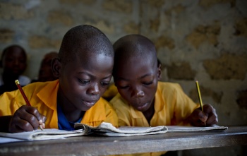 Children read together in a classroom in Liberia