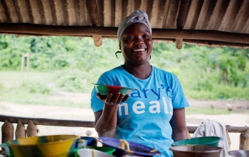 Volunteer cook in Liberia serving Marys Meals