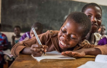 Child in Malawi learning in class