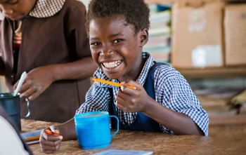 Girl in Zambia eating Marys Meals