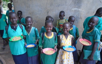 Smiling children with plates of Mary's Meals in South Sudan