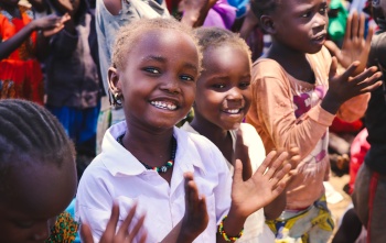Children in Kenya smiling and clapping along