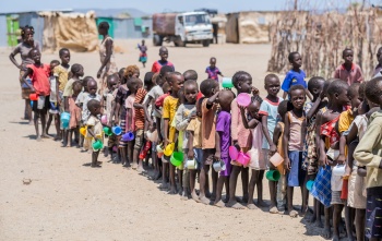 Children line up to be served food in Kenya
