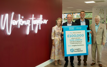 4 people stand in front of cheque presented to Mary's Meals charity by Insights