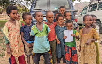 Children stand in front of the camera, outside, in Tigray, Ethiopia