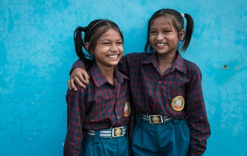 Twin sisters in India hugging