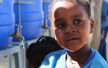 A close up image of a child in Ethiopia who has just washed their face