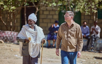 Mary's Meals Founder Magnus (right) in Ethiopia meeting a community member