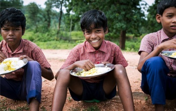 Boys eating Mary's Meals in India