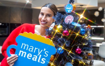 Ferne McCann with Mary's Meals sign next to Christmas Tree