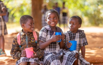 Image of three children eating their school meal