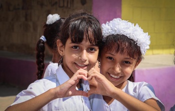 Two girls in Yemen after they have received their daily school meal