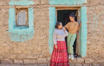 Lydia, right, and her mother, Shewit, left stand at an open doorway