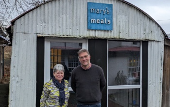 Julie Ramsay, Inner Wheel, with Mary's Meals Founder, Magnus MacFarlane-Barrow at the shed in Dalmally.