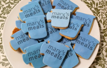 Biscuits shaped like mugs with Mary's Meals written on them