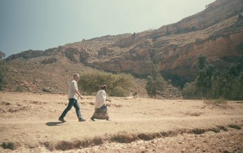 Magnus MacFarlane-Barrow walks in Tigray, Ethiopia, with a local woman.