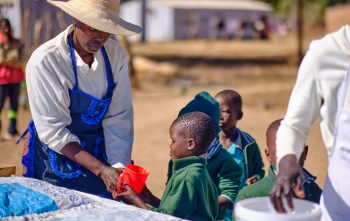 Child receiving Mary's Meals porridge