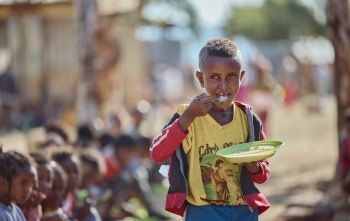 Boy eating porridge in Ethiopia