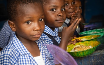 Children eating Mary's Meals' provided food