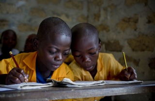 Children read together in a classroom in Liberia