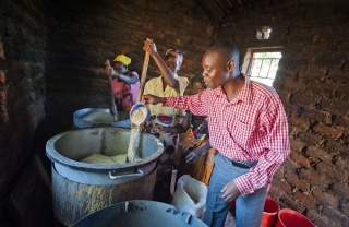 Volunteers gather around a stove to prepare food