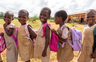 Children in Benin queuing for their school meal