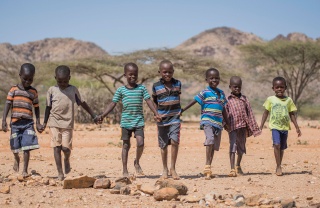Children walking holding hands in Kenya