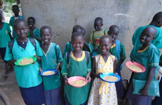 Smiling children with plates of Mary's Meals in South Sudan