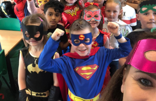 Primary pupils dressed in superhero costumes