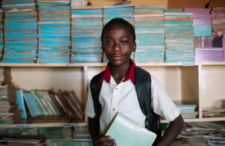 Samuel, 13, at school holding a book