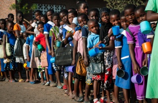 Children queueing for serving of Mary's Meals