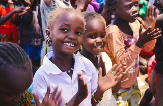 Children in Kenya smiling and clapping along