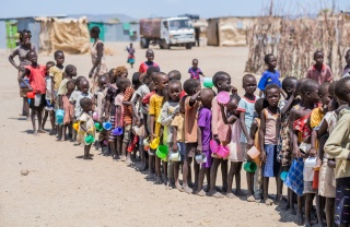 Children line up to be served food in Kenya