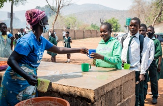 child receiving serving of Mary's Meals