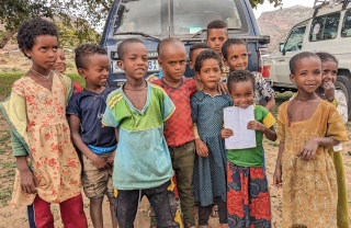 Children stand in front of the camera, outside, in Tigray, Ethiopia