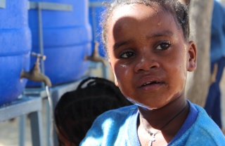 A close up image of a child in Ethiopia who has just washed their face