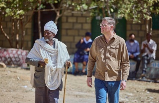 Mary's Meals Founder Magnus (right) in Ethiopia meeting a community member
