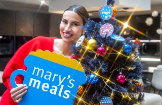 Ferne McCann with Mary's Meals sign next to Christmas Tree