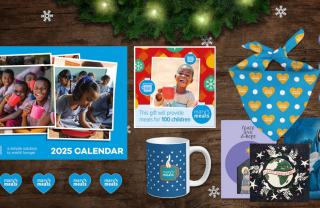 A selection of the Christmas gifts that can be found on the Mary's Meals online shop. Calendar, pin badges, gift cards, Christmas cards, dog bandana and mug.