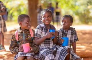 Image of three children eating their school meal