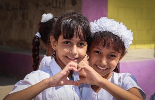 Two girls in Yemen after they have received their daily school meal