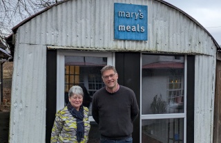 Julie Ramsay, Inner Wheel, with Mary's Meals Founder, Magnus MacFarlane-Barrow at the shed in Dalmally.