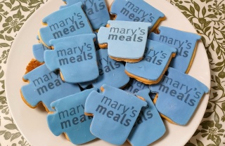 Biscuits shaped like mugs with Mary's Meals written on them