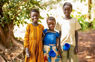 Three children standing with mugs